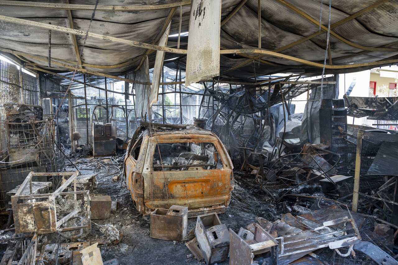 A torched house and car.