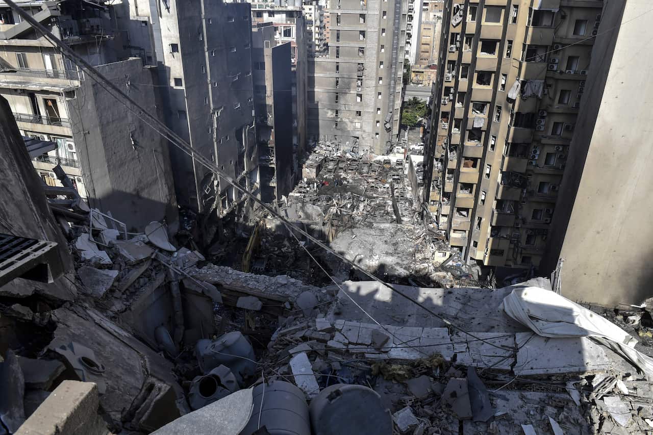 Aerial view of some destroyed buildings surrounded by tall apartment blocks