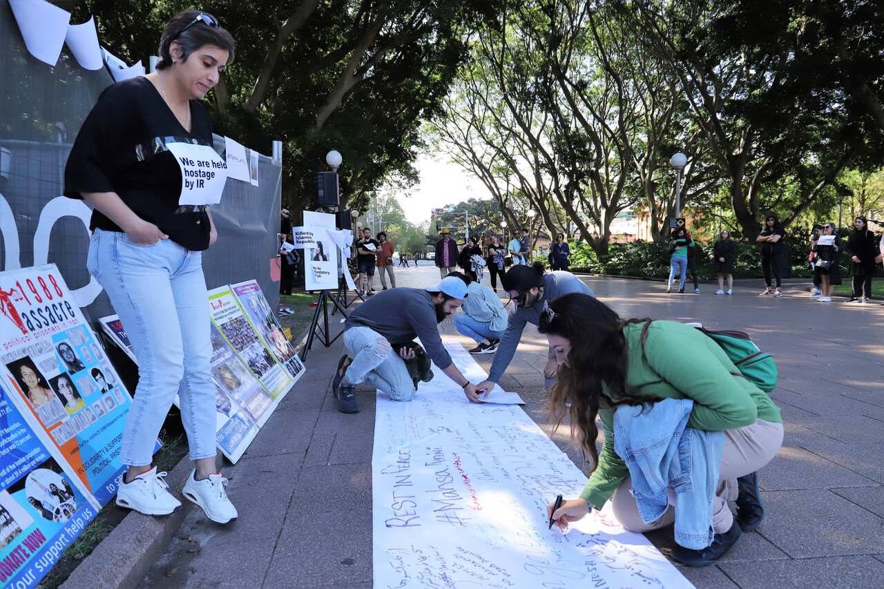 messages to resonate rage and solidarity for Mahsa Amini-  Sydney Hyde Park- Credit: Damon AMB