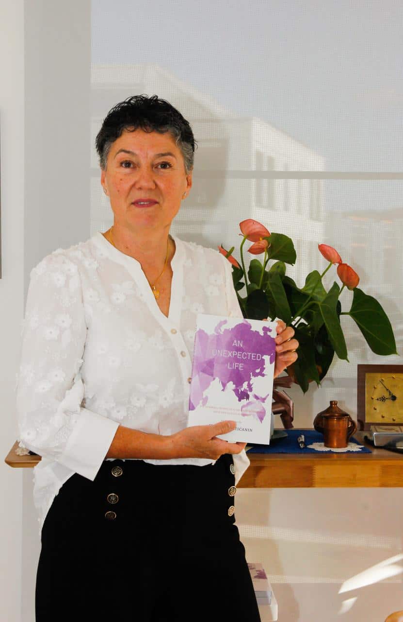 Author Vesna Cvjeticanin poses with her book An Unexpected Life