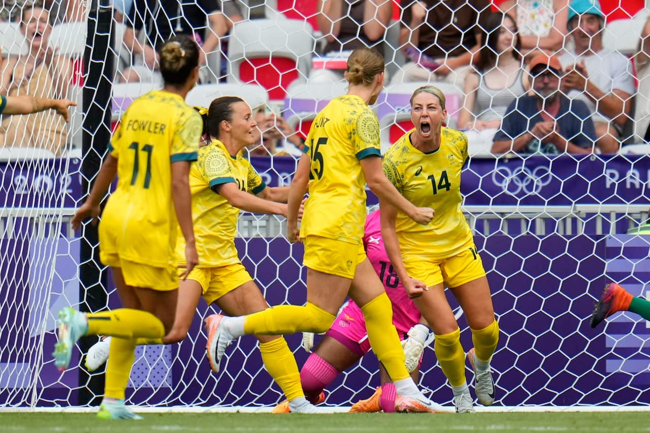 Australia's Alanna Kennedy and her teammates celebrate scoring the opening goal against Zambia.