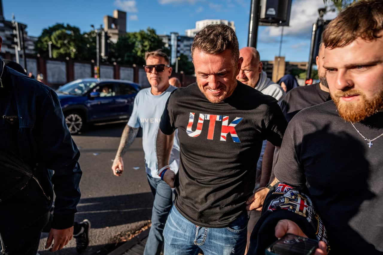 Tommy Robinson in a "UTK" Union Jack shirt.