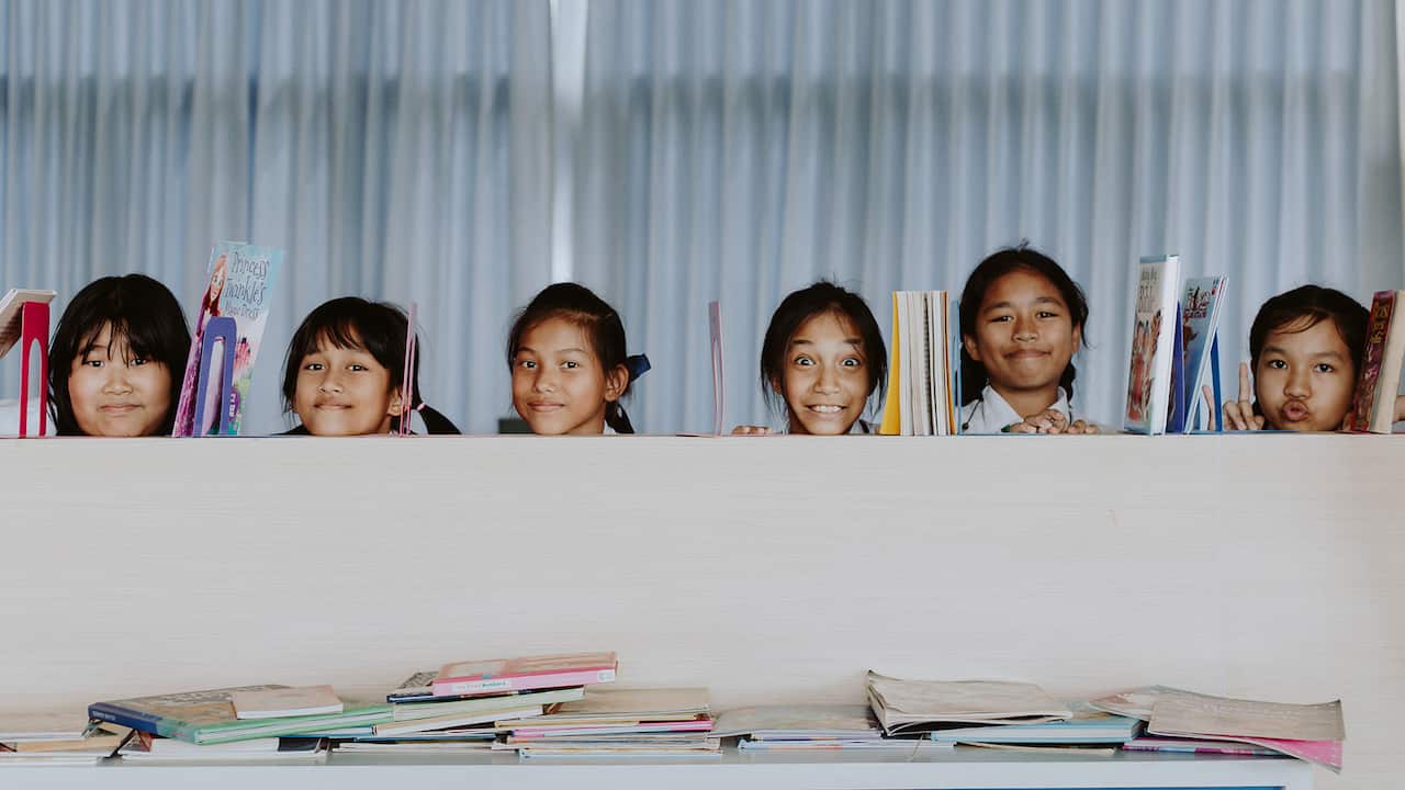 School Girls Behind Bookshelf in Classroom. Pexels Ron Lach.jpg