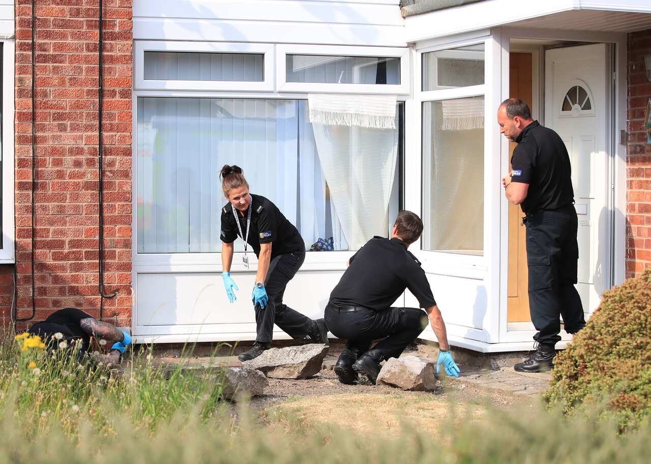 Police investigating a house.