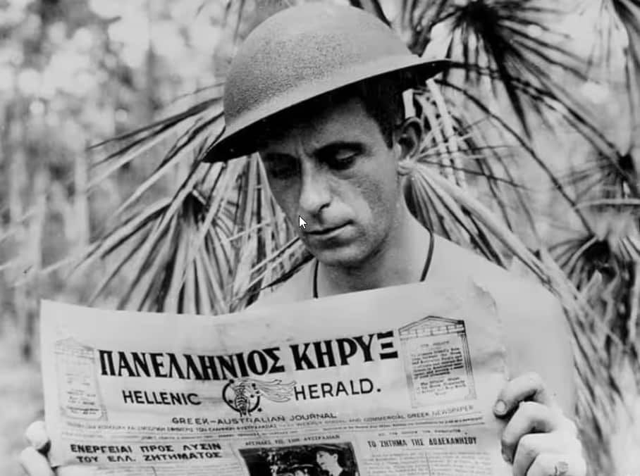 Royal Australian Air Force Xenophon Castrisos reading the Hellenic Herald during World War II, somewhere in the Pacific..png