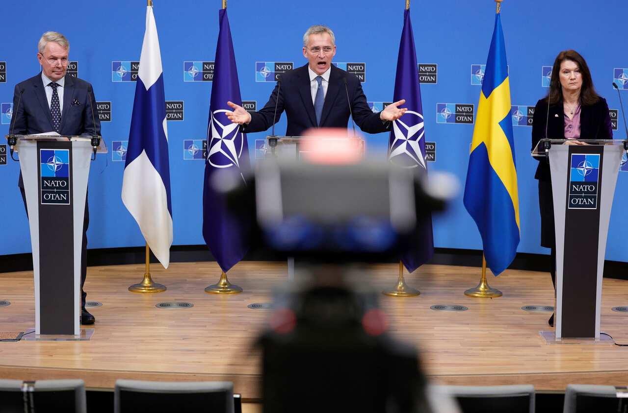Three people standing behind lecterns.