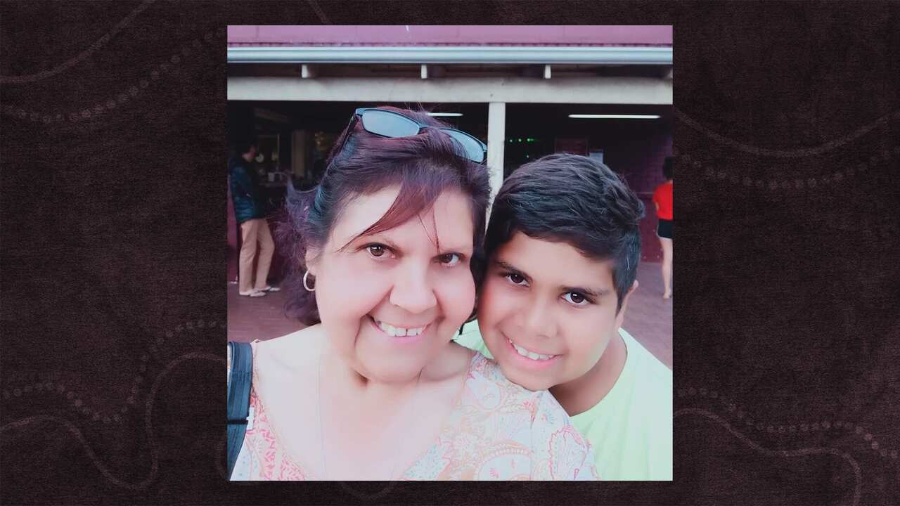 Cassius Turvey and his mother smile for a photo together