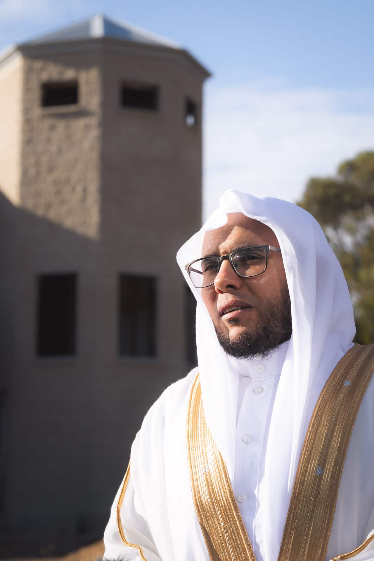 Emad Hamdy, Imam at the Young mosque, standing outside the place of worship.