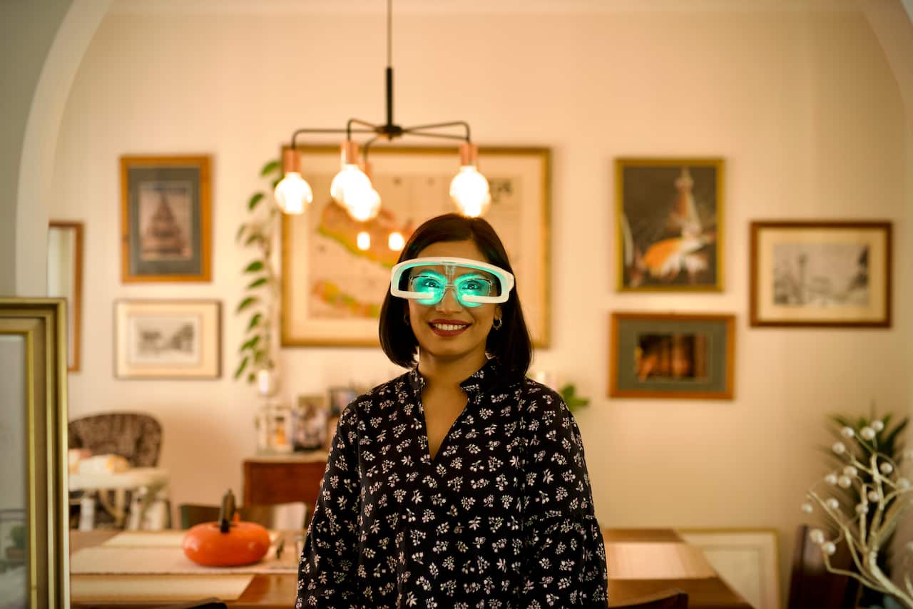 A woman wearing large white glasses that emit light