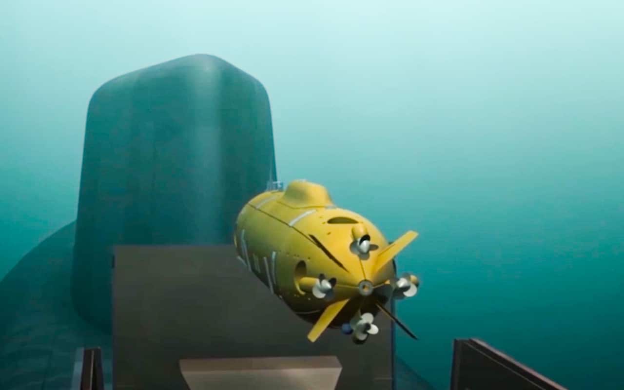 Yellow underwater glider next to submarine. 