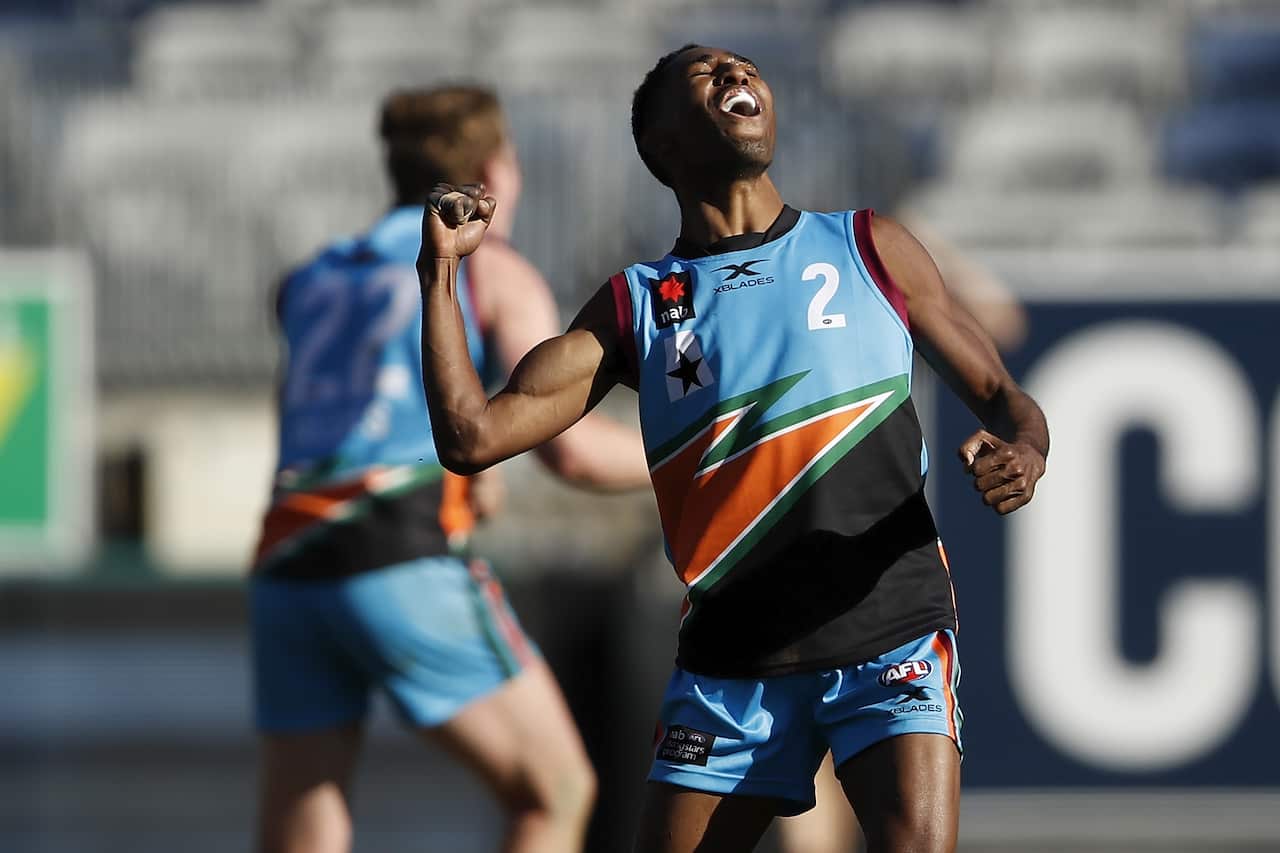 Hewago Oea celebrates on an Aussie rules field