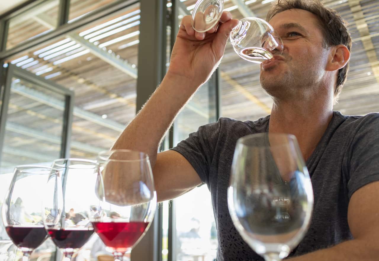A man is wine tasting in the Adelaide Hills