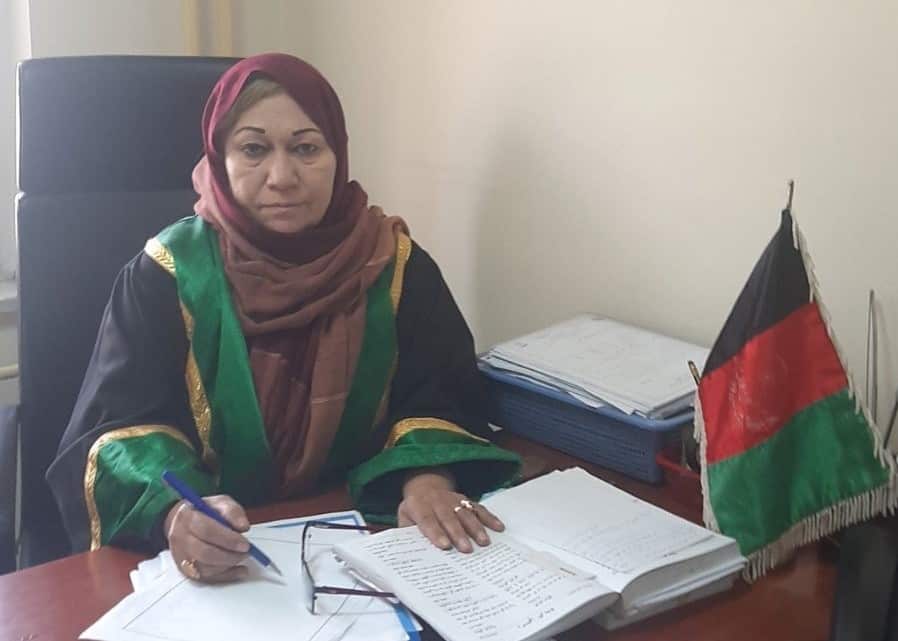 Judge Shakila Abawi Shigarf sitting at a desk in her office.