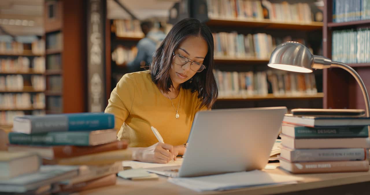 Young woman in a library studying