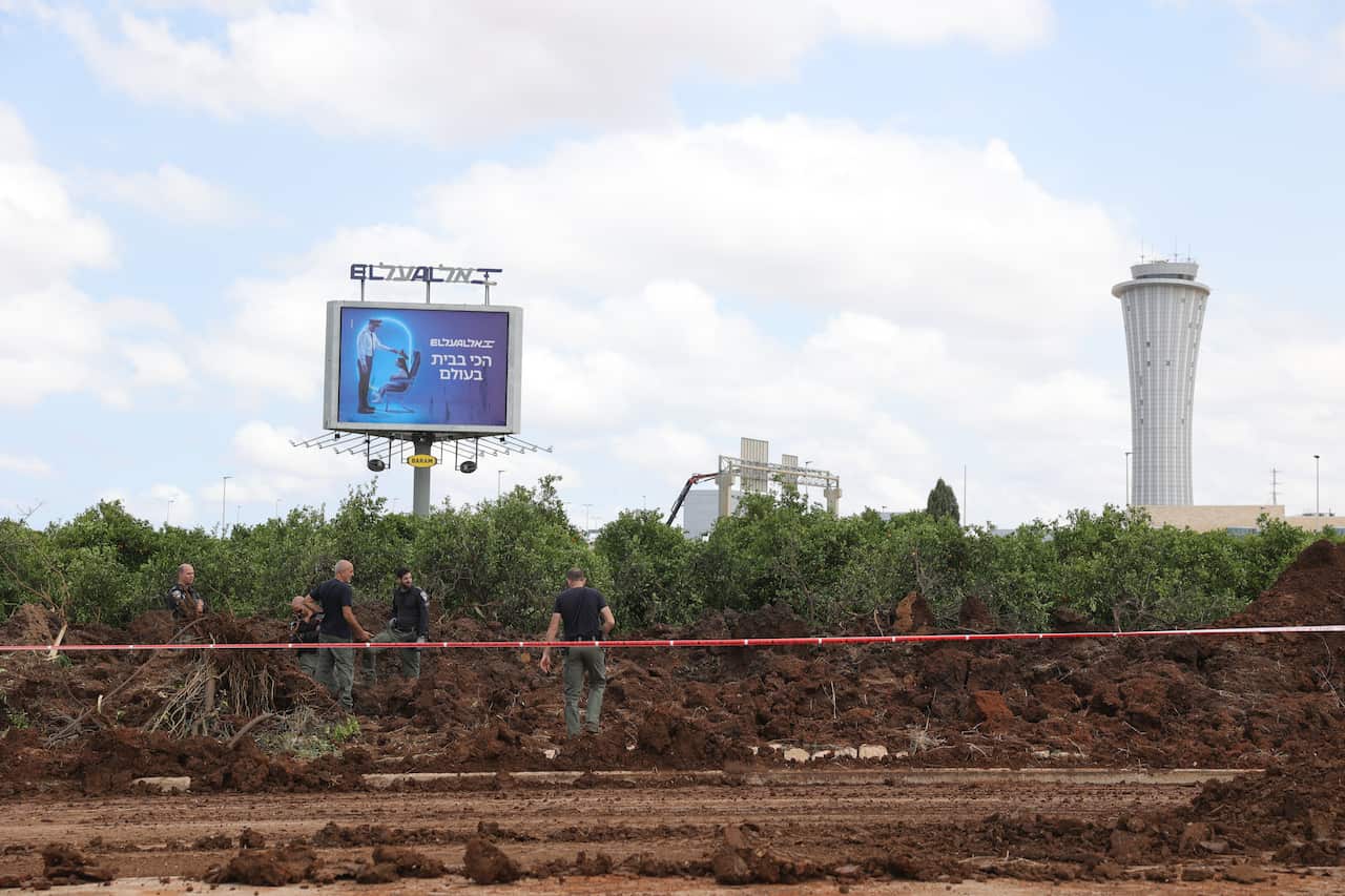 Officials inspect a site struck by a missile.