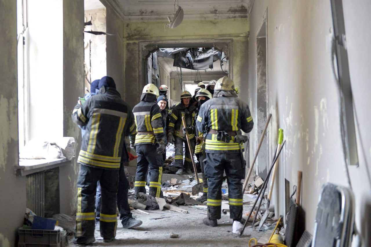 Emergency personnel work in the damaged local city hall of Kharkiv