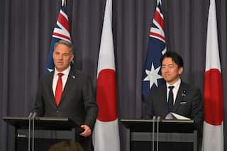Richard Marlesand Koizumi Shinjiro speaking at podiums.