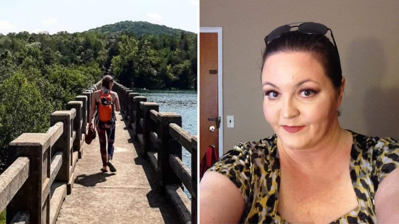 Woman walking next to water on a bridge. 