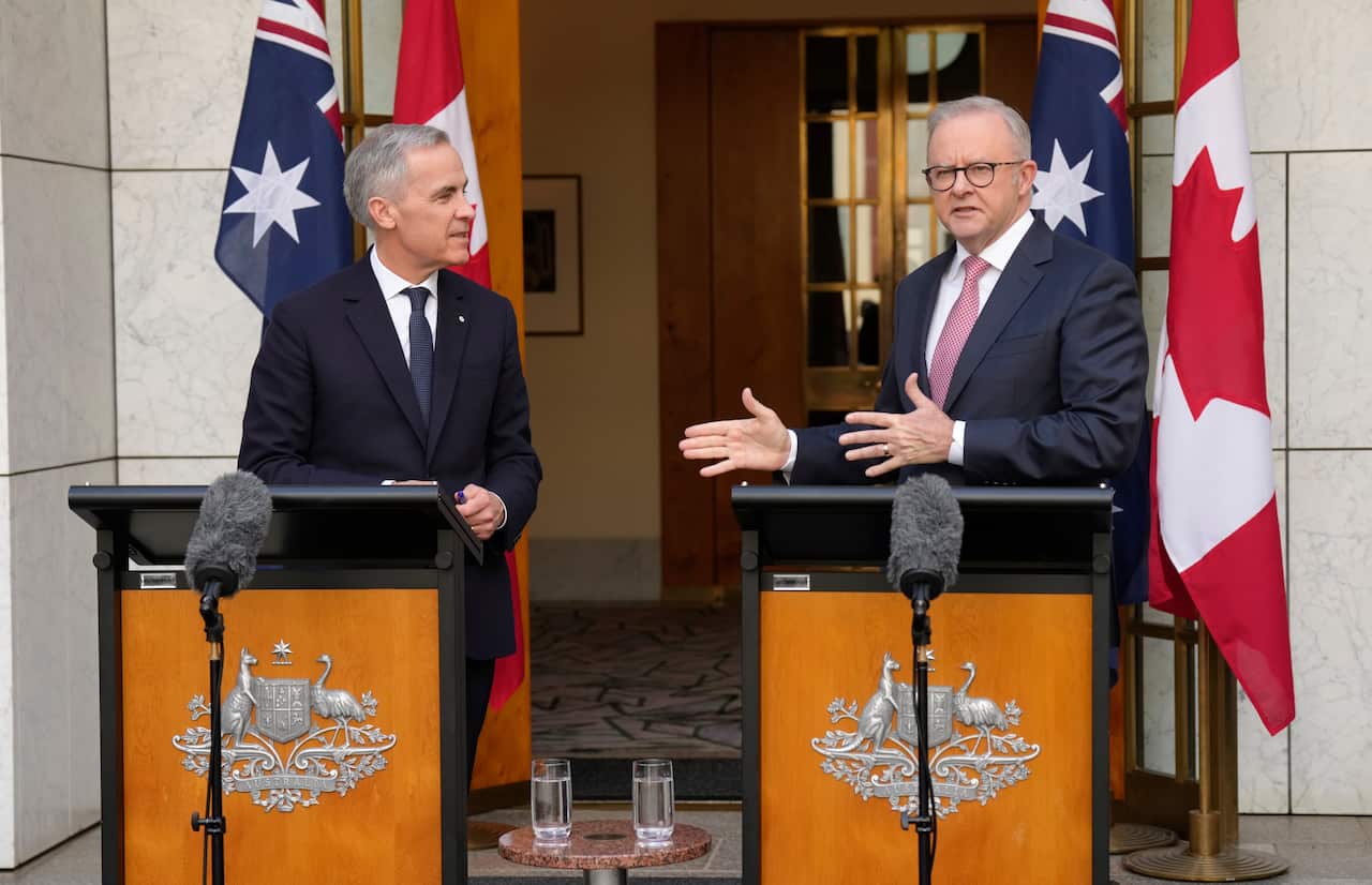 Mark Carney and Anthony Albanese speaking at podiums outside Parliament House.
