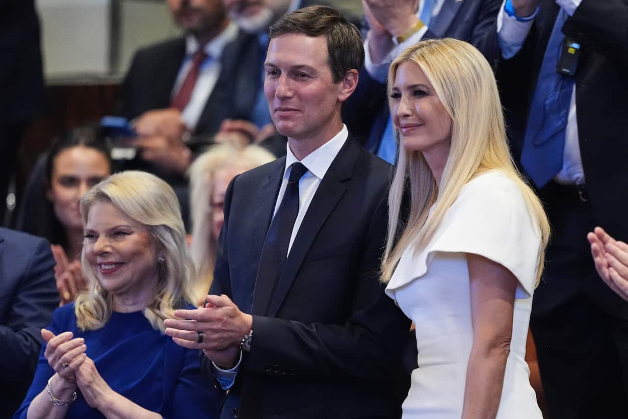 Jared Kushner claps as Ivanka Trump stands next to him. 