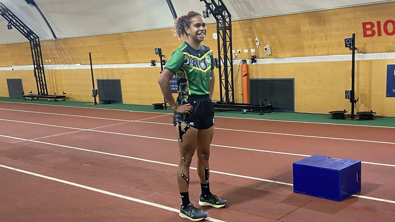 Turby league player standing on indoor track