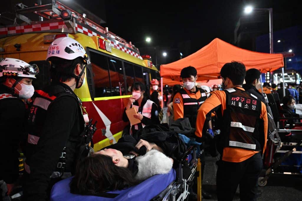 Medical staff attend to a person on a stretcher in the popular nightlife district of Itaewon in Seoul after a stampede at a Halloween event crushed many to death.