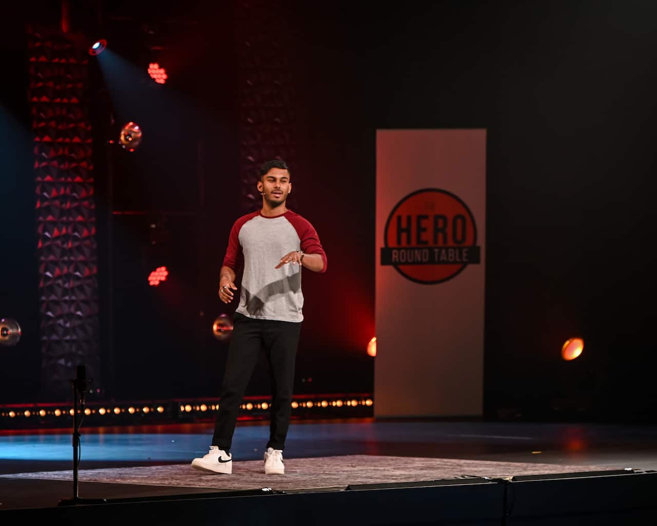 A young man speaking on a stage