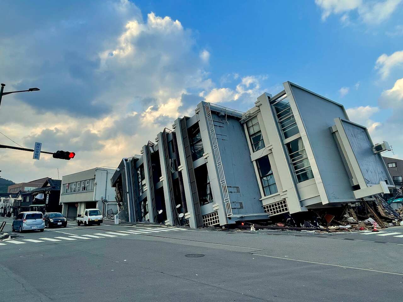 A five-storey buidling collapsed on its side.