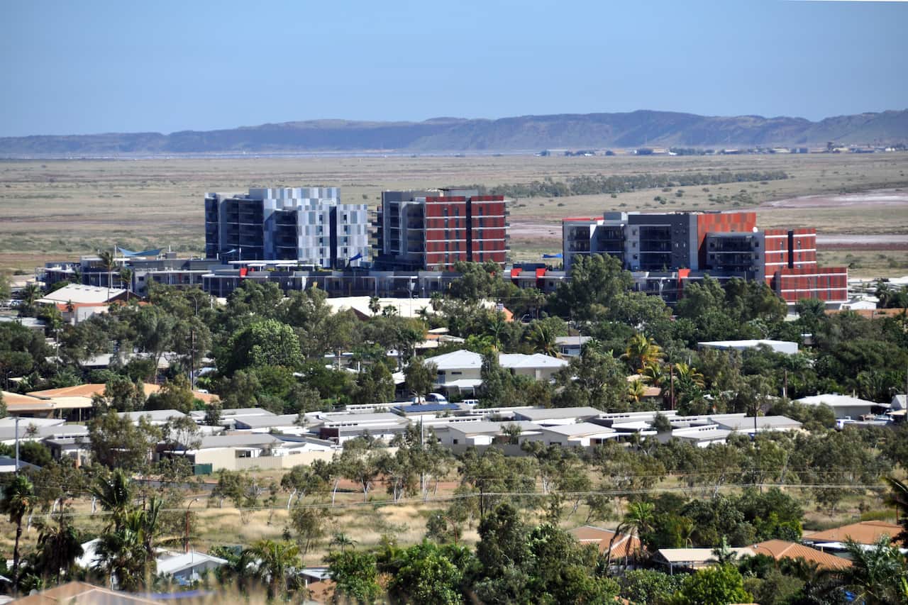 An aerial shot of a country town with apartments and open green spaces.