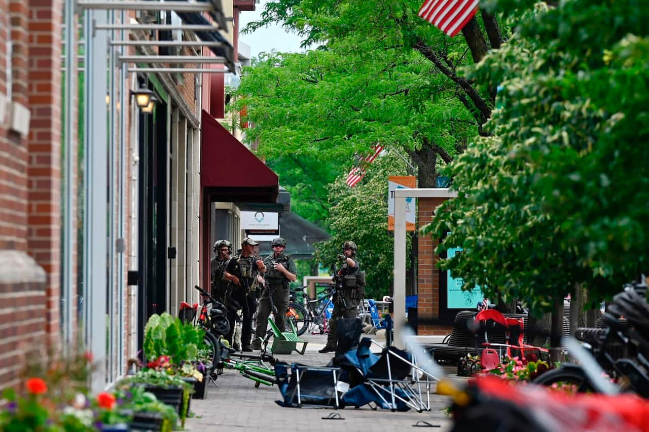 Police search the area after the mass shooting. 