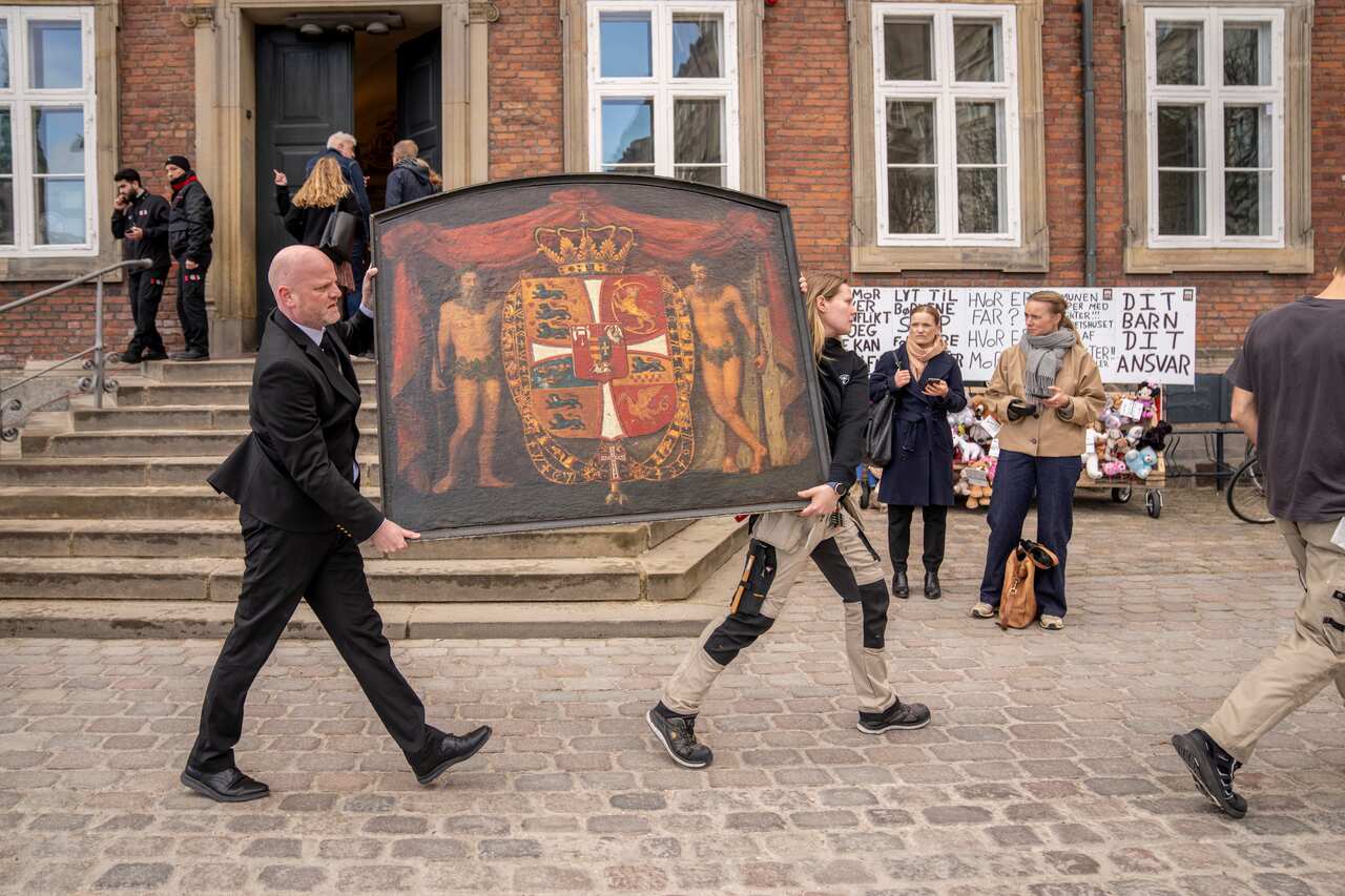 Paintings being carried out of a burning building. 