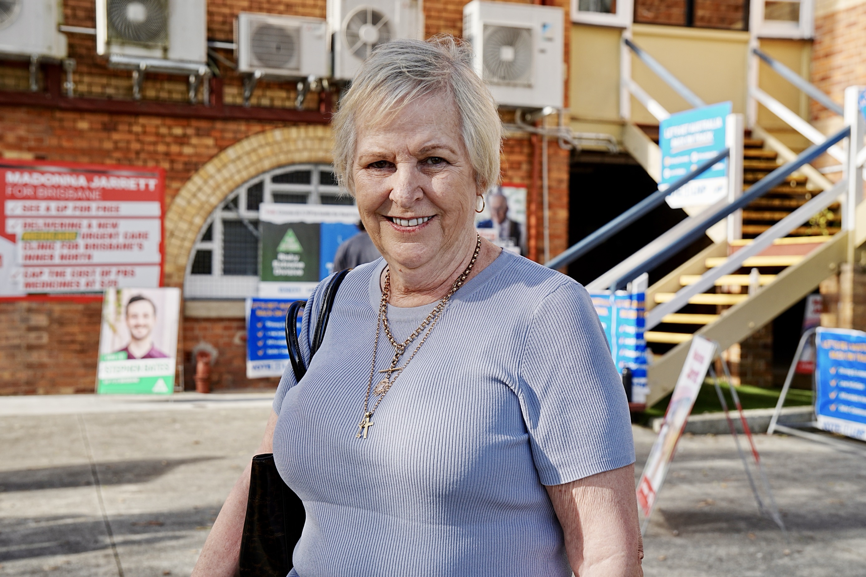 A woman smiles outside a polling station