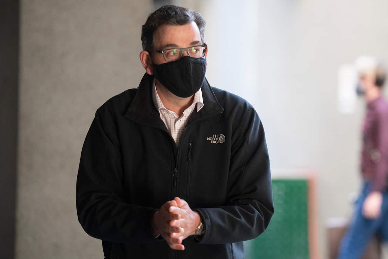 Daniel Andrews wearing a black face mask and a North Face jacket. 