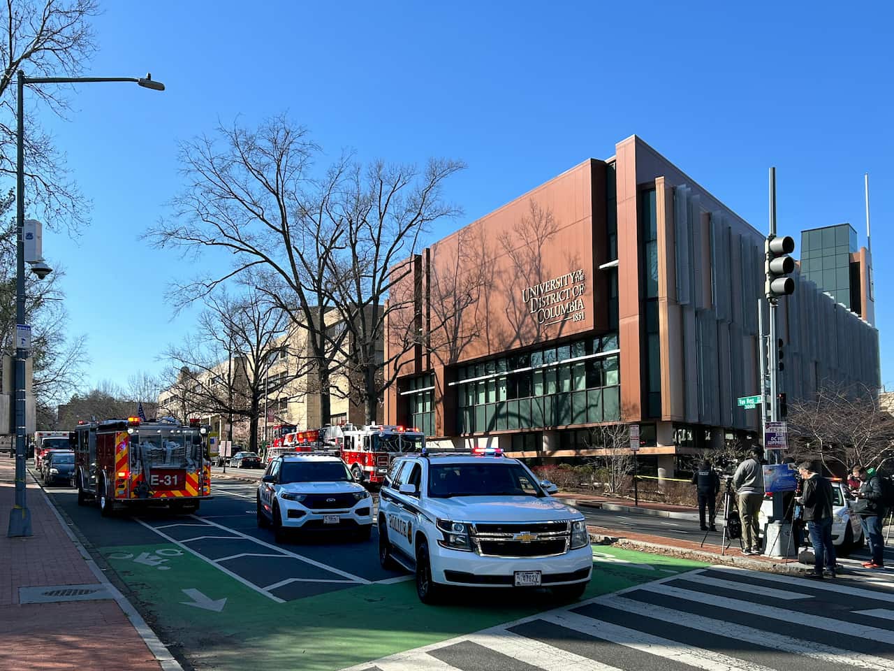 White vehicles and fire engines in a street