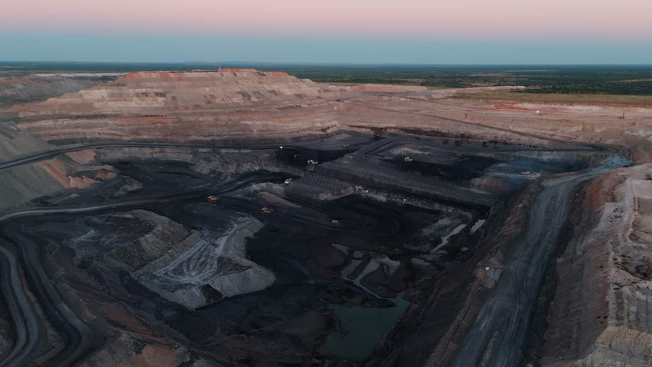 A drone shot of the blackened pit at a coal mine.