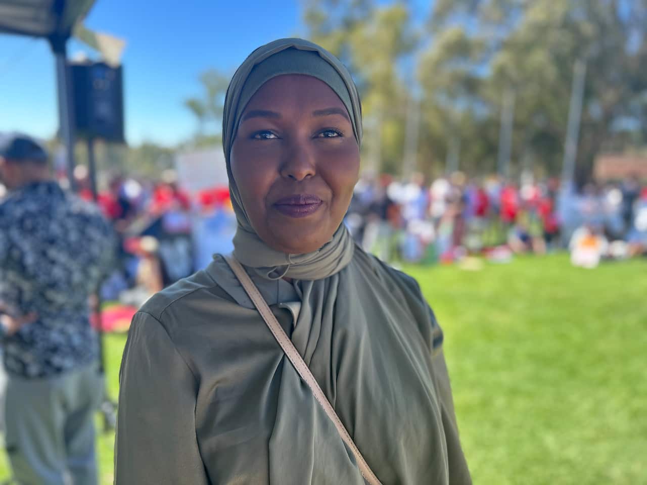 Woman in hijab looks towards camera.