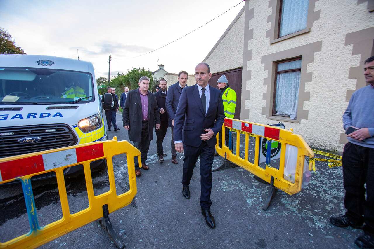 Ireland's prime minister arriving at the scene of a petrol station explosion.