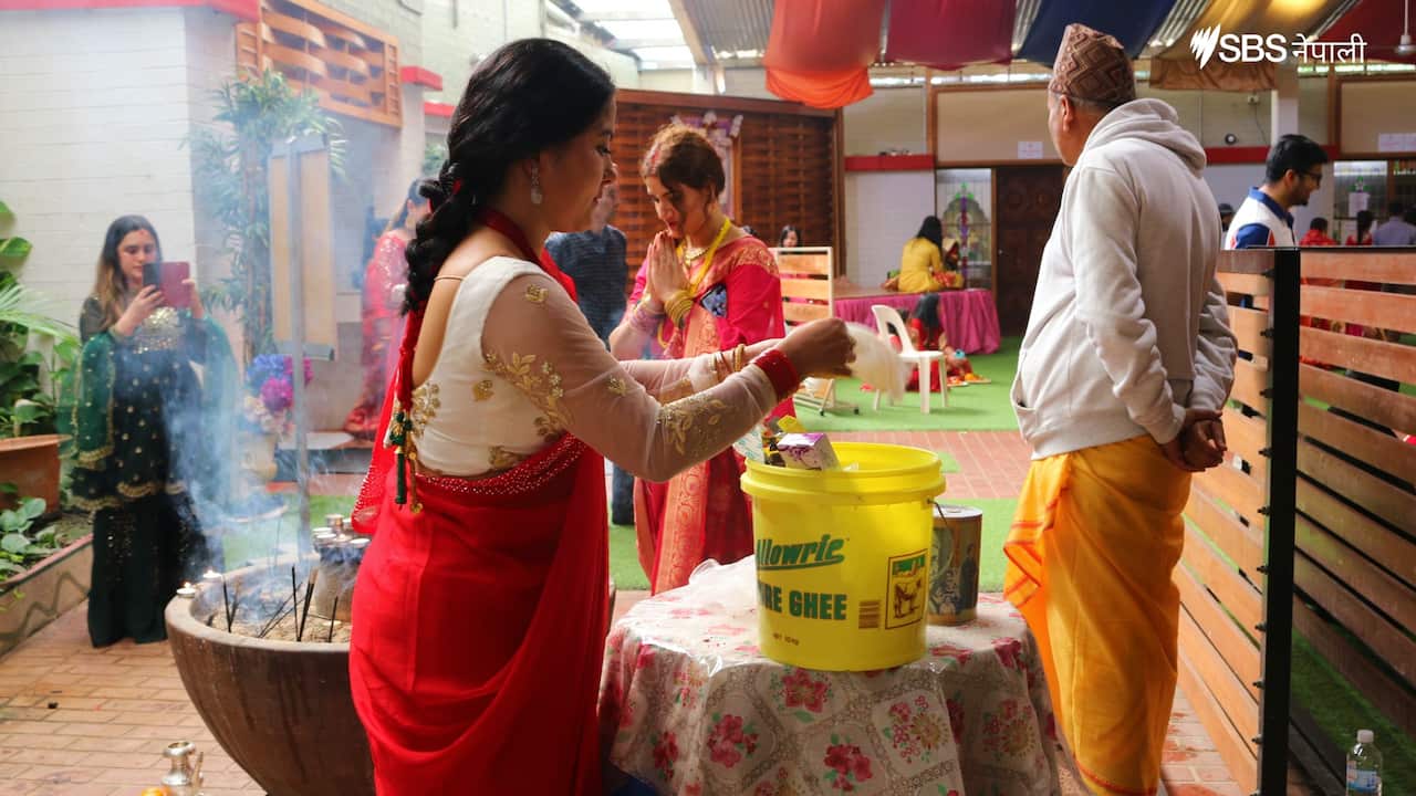 People worship in the presence of a priest during Teej festival in Sydney's Mukti-Gupteshwar temple. 