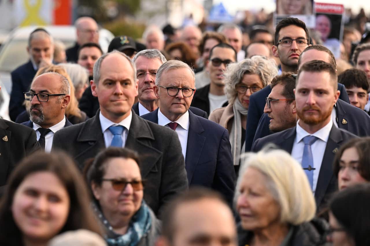 A crowd of people attend a rally.