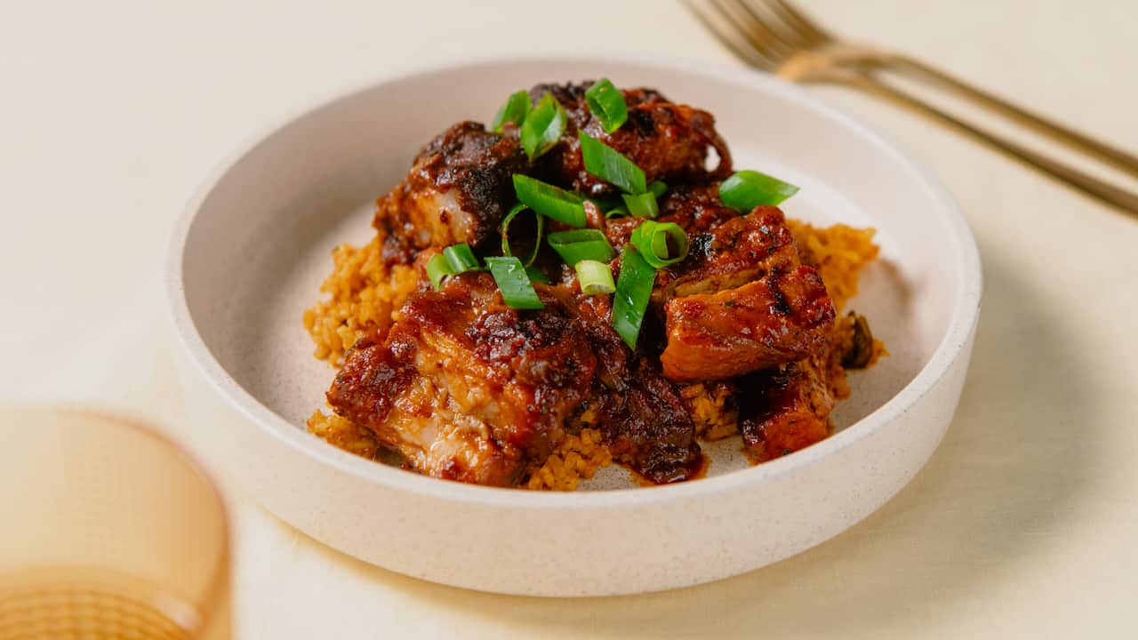 Braised pork ribs in tomato stew & jollof rice