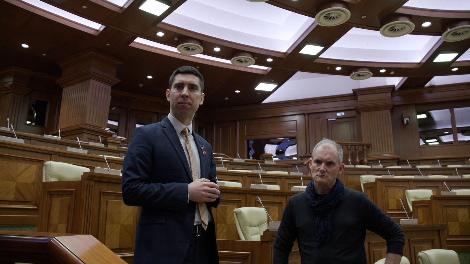 Moldovan Parliament deputy speaker, Mihail Popsoi (left) and Dateline reporter Evan Williams (right) stand in the parliament chamber.