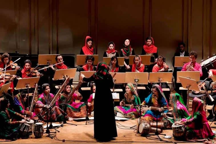An all-female orchestra performing on stage
