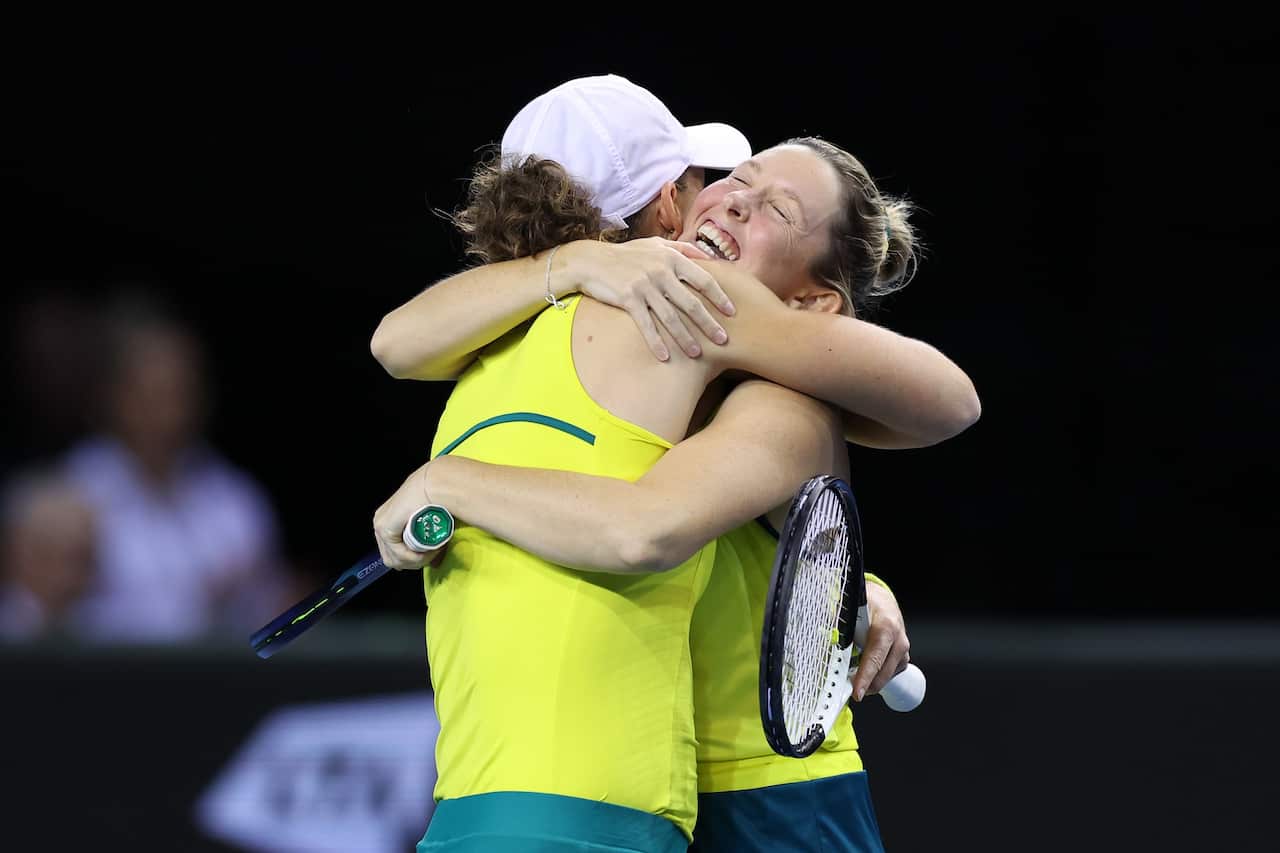 Storm Sanders and Samantha Stosur hug in celebration of winning the semi-final match between Team Australia and Team Great Britain.