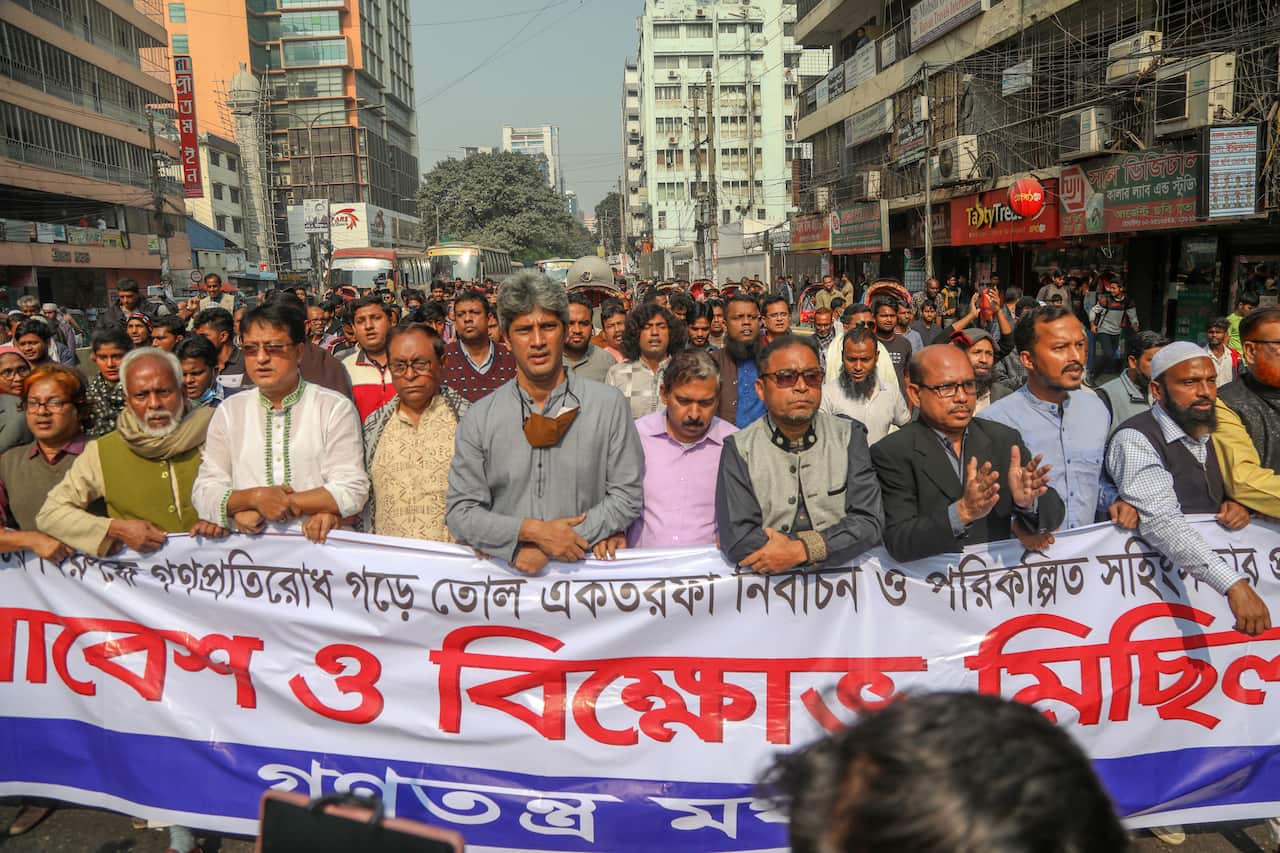 People hold a banner during a protest