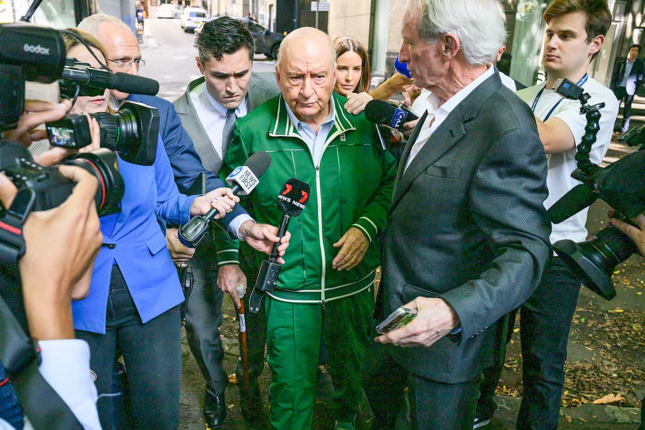 A man wearing a green tracksuit