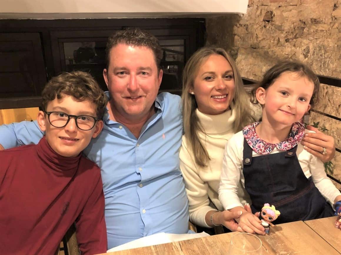 (left to right) A boy, a man, a woman and a girl sitting at a table