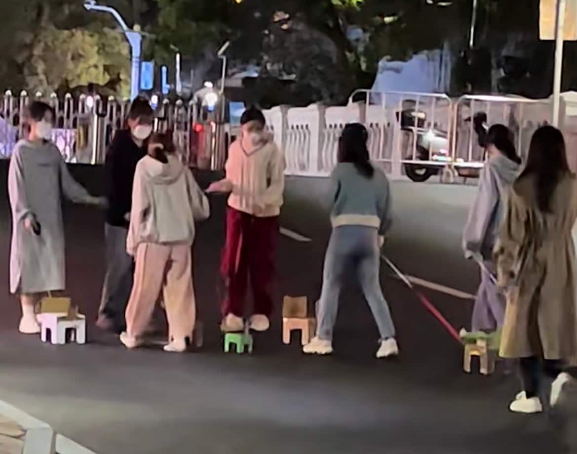 chinese university students walking paper dogs.png