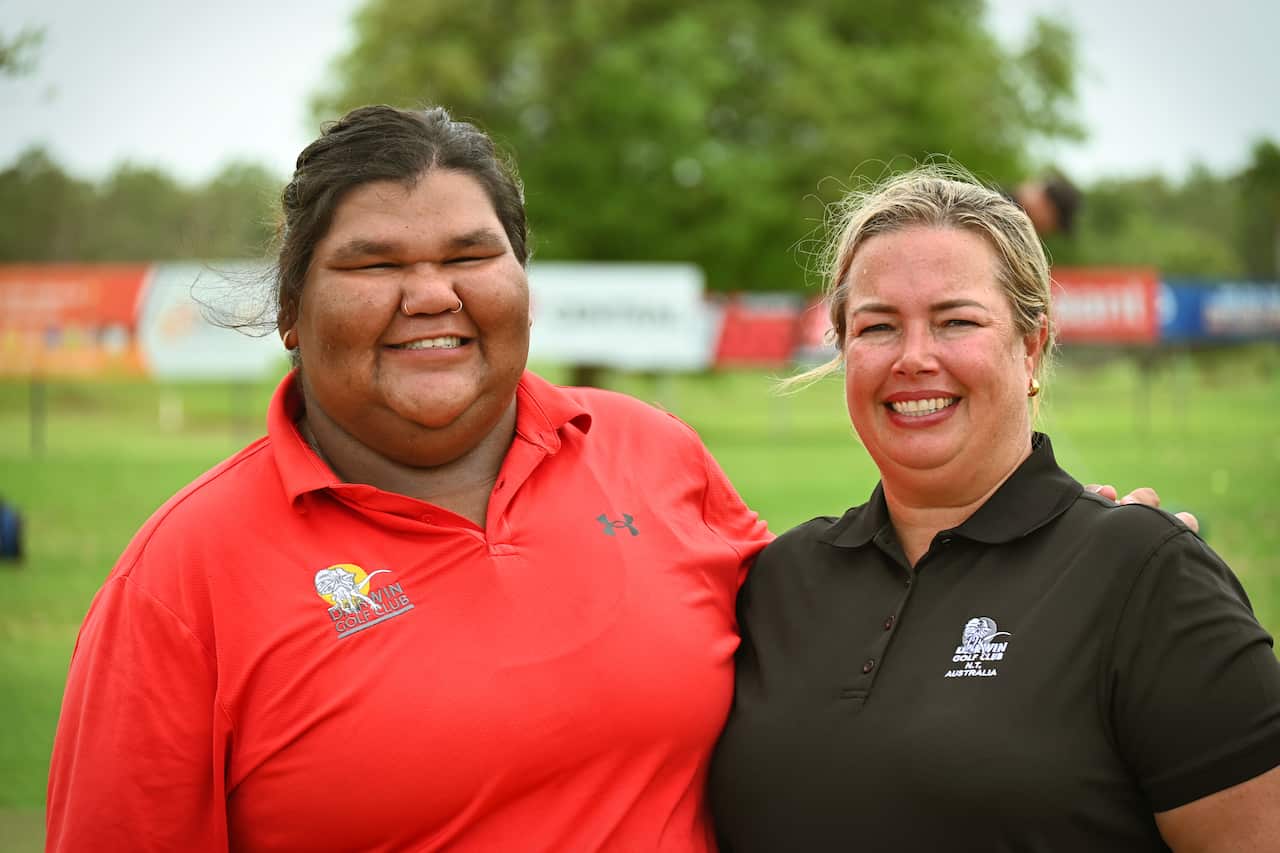 Amateur golfer Skye Lampton stands next to Darwin Golf Club Captain Amy Griesbach before the pair head out to play a round of golf.
