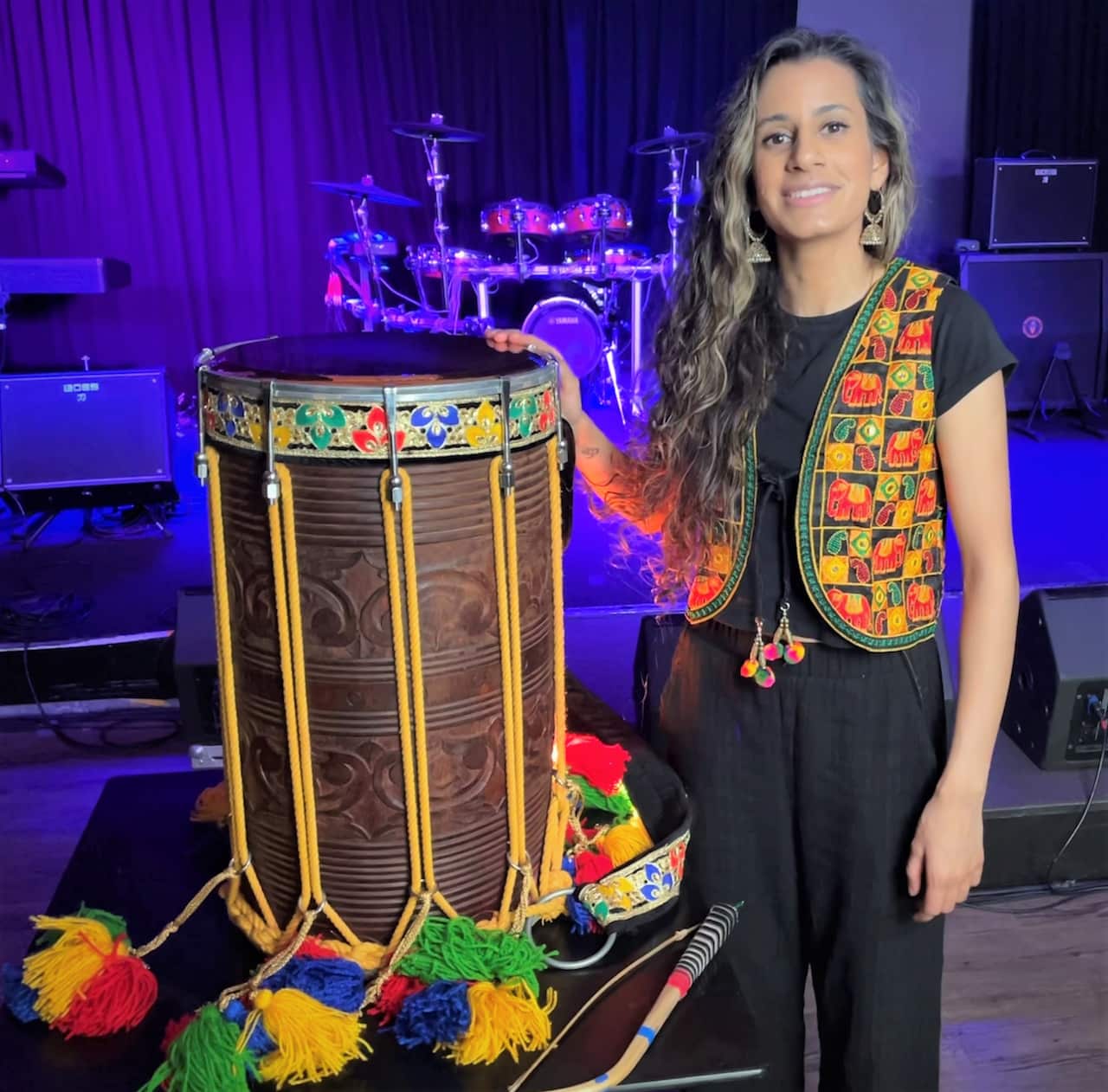 Priya Gakhar standing next to her dhol.