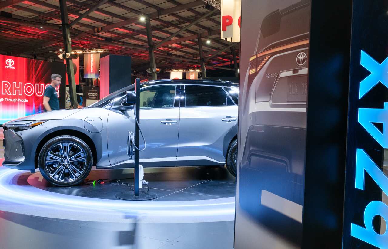 A grey electric vehicle in a showroom.